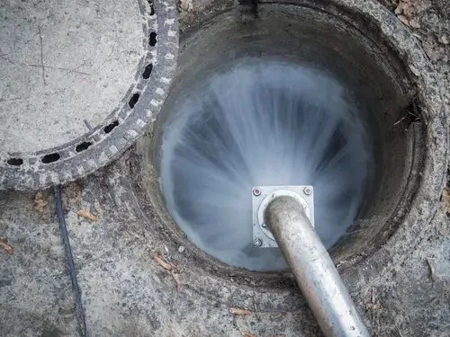 High-pressure water jetting cleaning the inside of a drainage chamber