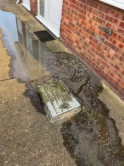 Drainage engineer opening a manhole to deal with an urgent drainage problem